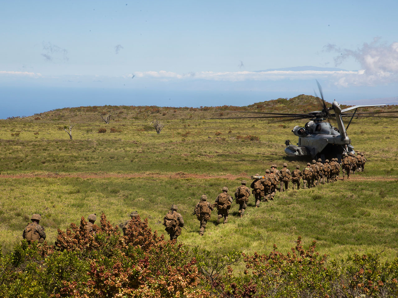 soldiers marching towards helicopter 