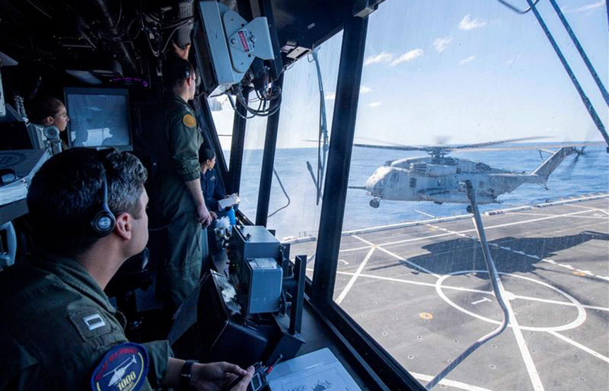 person looking out at helicopter about to take off