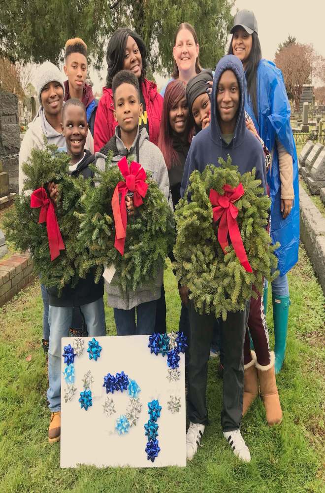 People holding wreaths