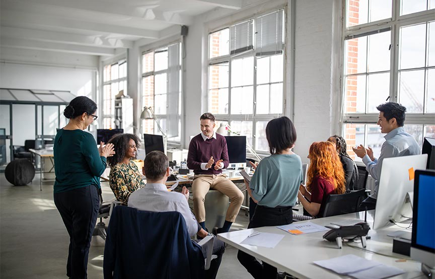 group of coworkers in a office talking together