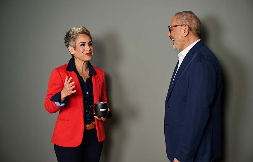woman and man standing together talking 