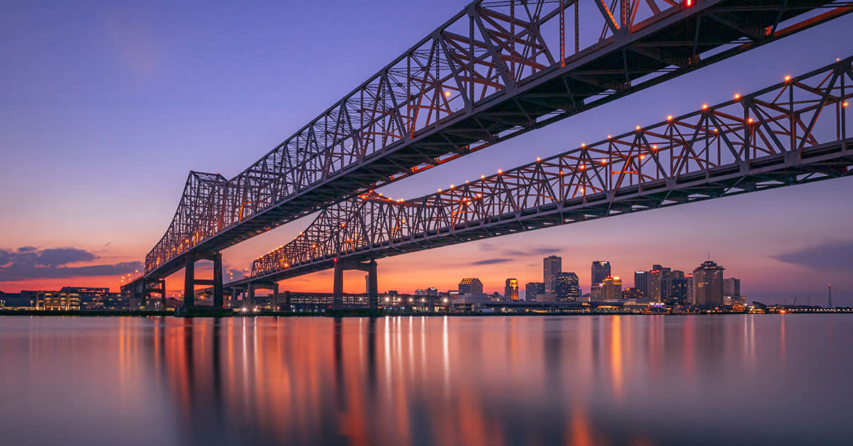 sunset behind bridge in New Orleans, LA