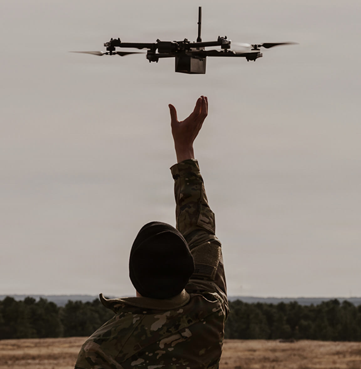 military service member launching a drone in the sky