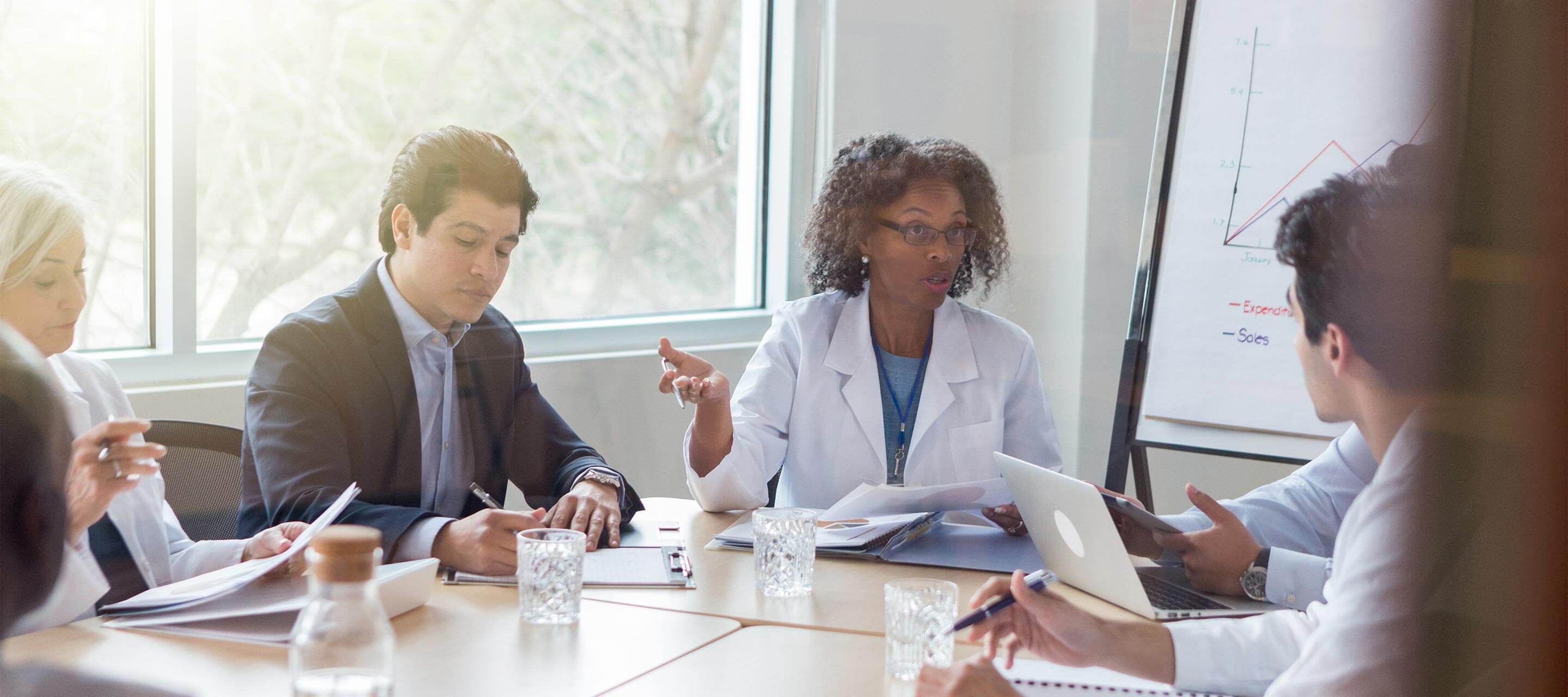 doctors in meeting with people in suits