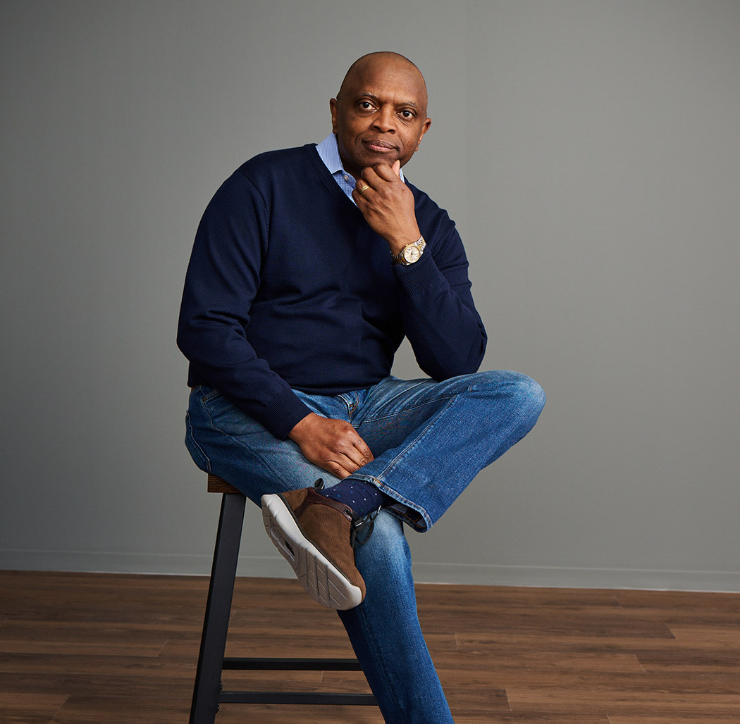 professional man sitting on stool