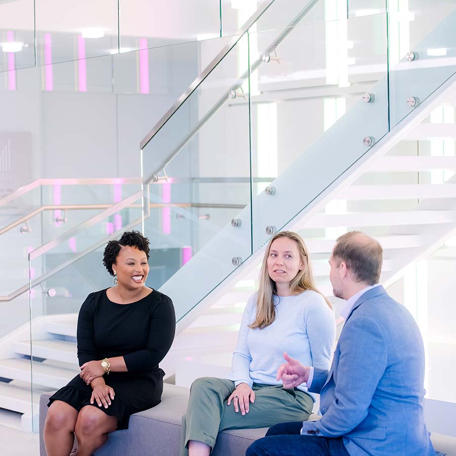 coworkers talking together on a bench 