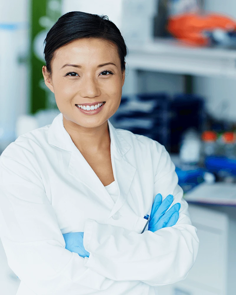 scientist with white lab coat and blue sterile gloves