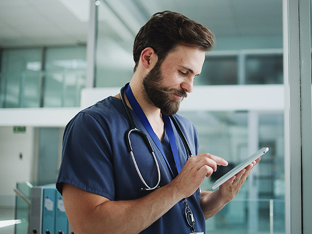male doctor on ipad