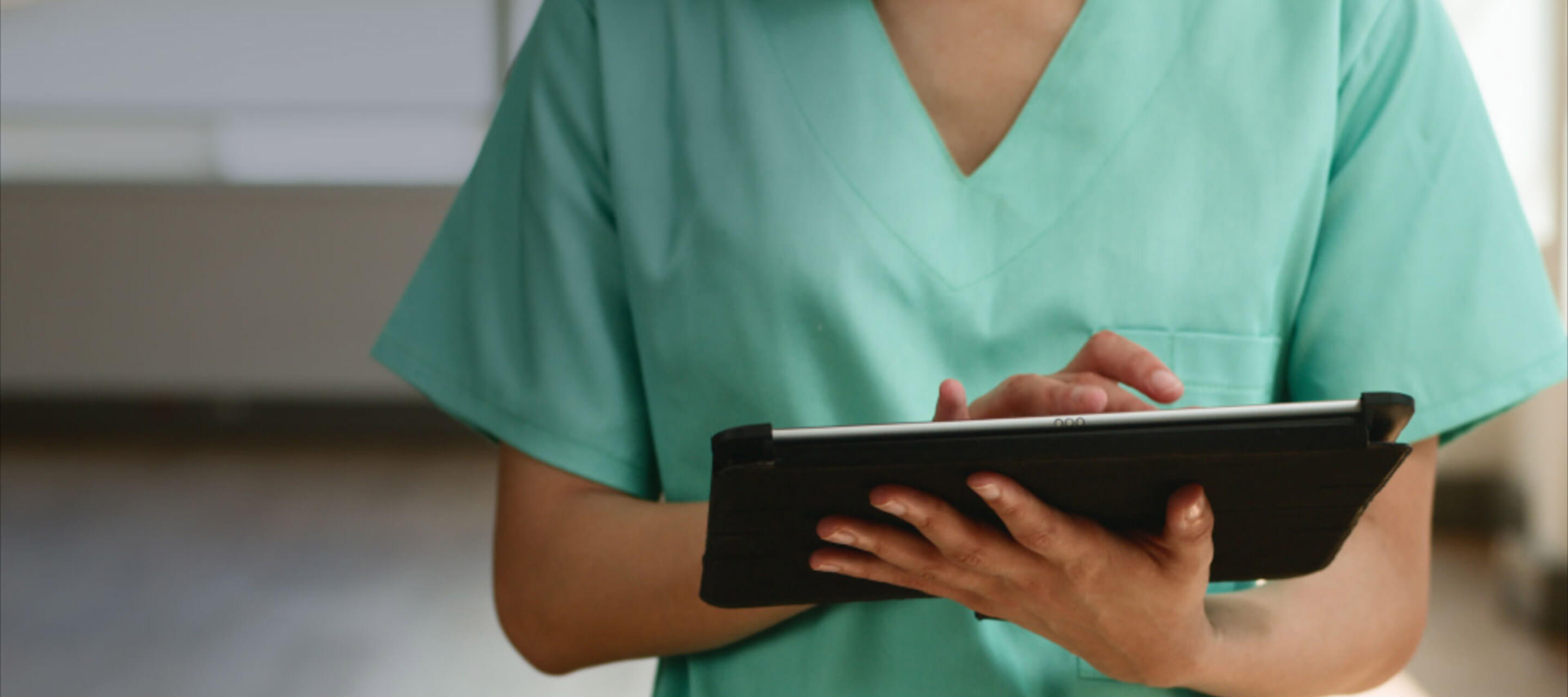 nurse looking at tablet
