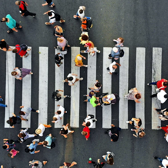aerial view of pedestrians walking across the street