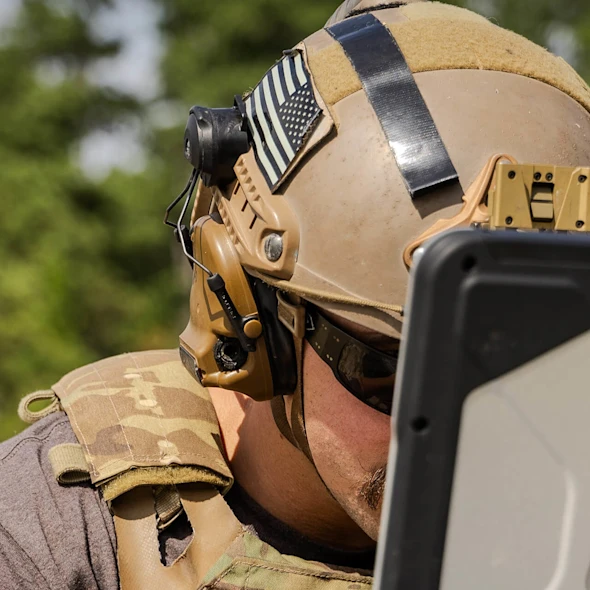 soldier looking at his laptop