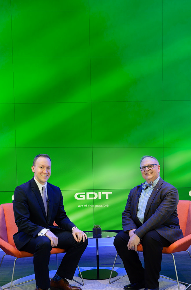 GDIT's Tim Gilday and John Sahlin pose together after a discussion on the importance of zero trust at the edge