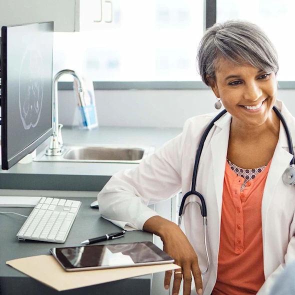image shows female doctor talking to patient in the office