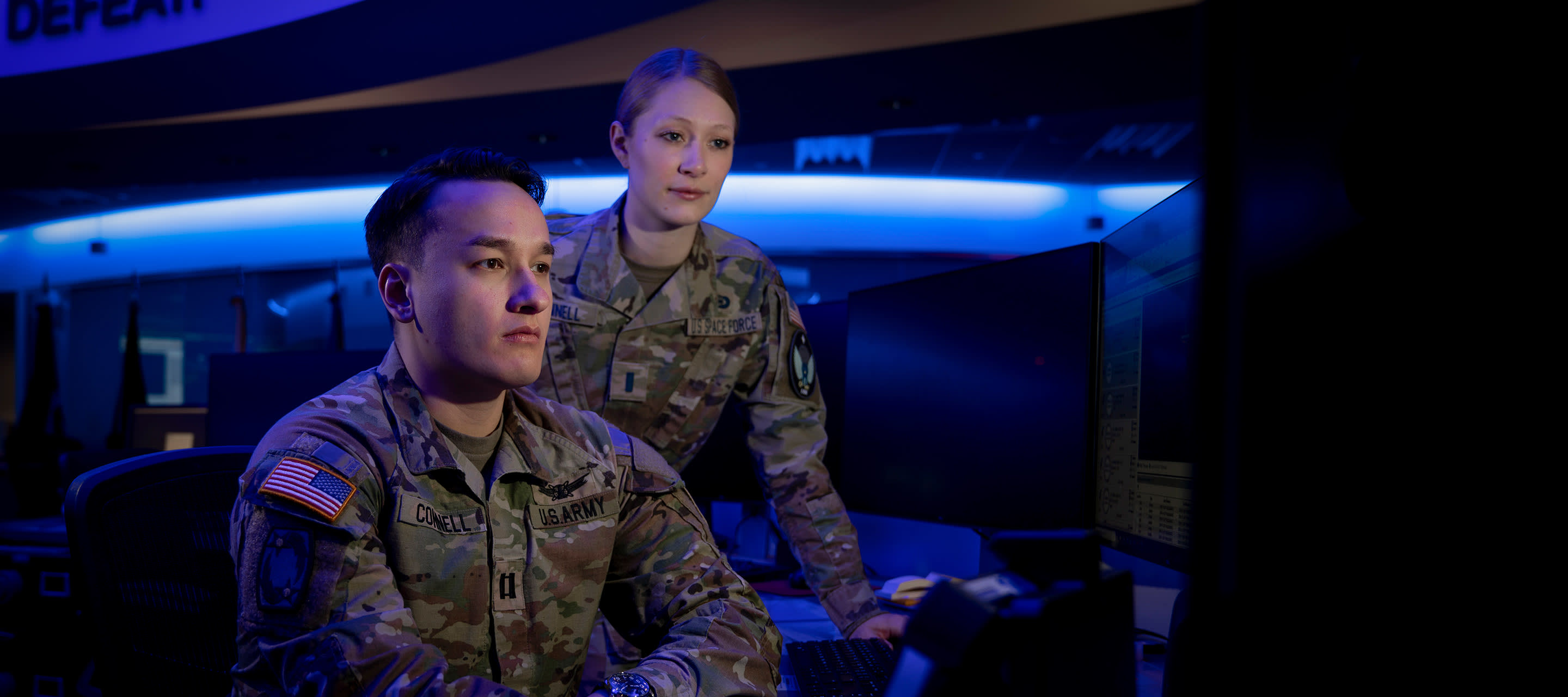 two soldiers looking at a computer