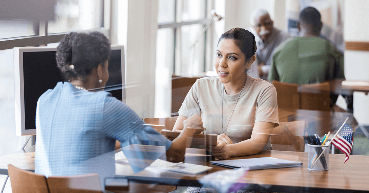 female soldier talking to a specialist at a desk