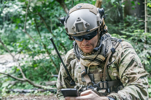 Solider looking at a cellphone