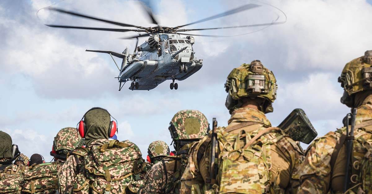 soldiers looking at helicopter 