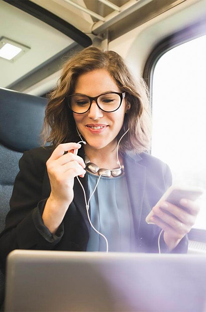 woman on the plane, using cell phone + wired headphones 