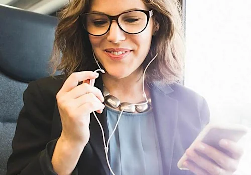 woman on the plane, using cell phone + wired headphones