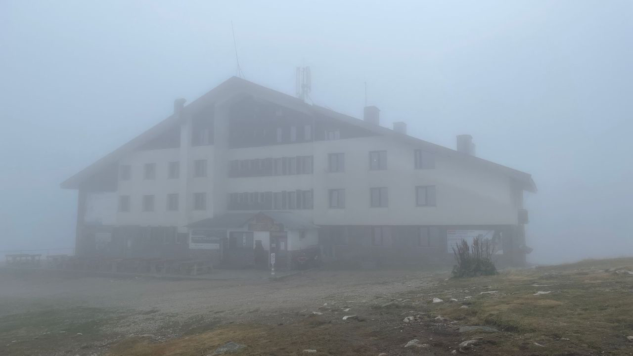 rila mountain building in fog