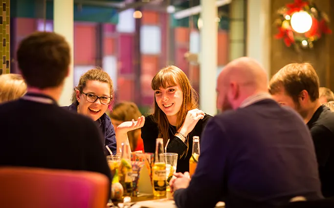 Smiling group of guests at a table