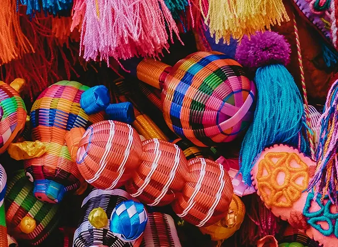 Assorted colourful baskets and woven goods in a Mexican market
