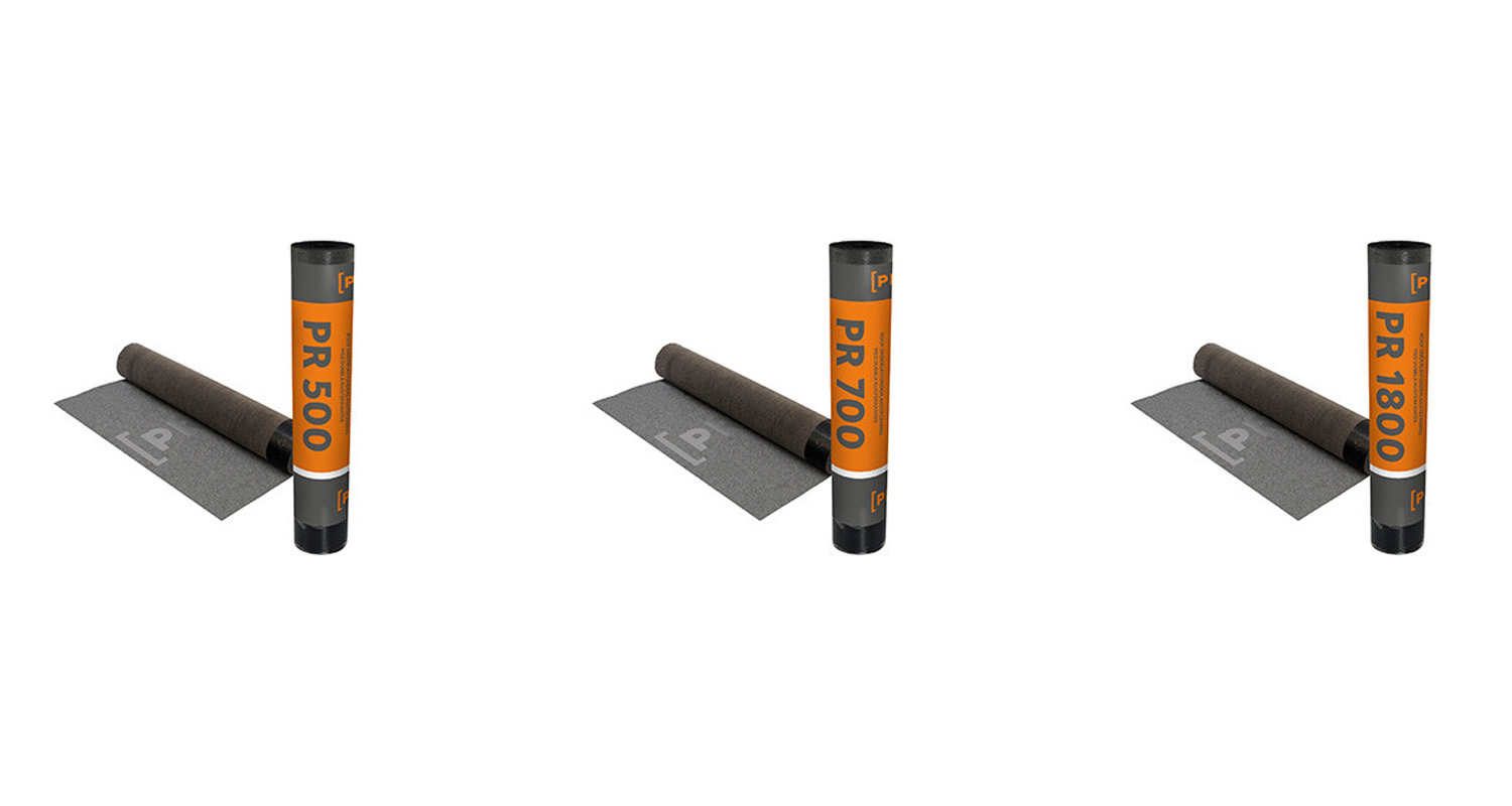 Tre takrullar med orange etiketter PR 500 PR 700 och PR 1800 intill utrullade mörkgrå mattor