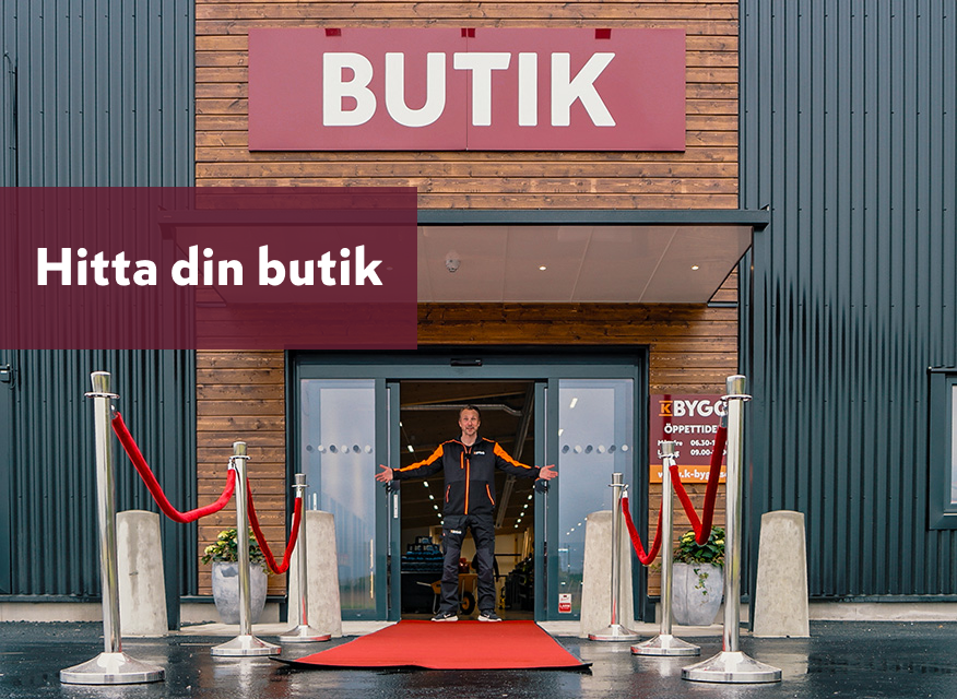 en byggnad med en stor skylt där det står "K BYGG". Under skylten finns mindre text som lyder "Hitta din butik". 