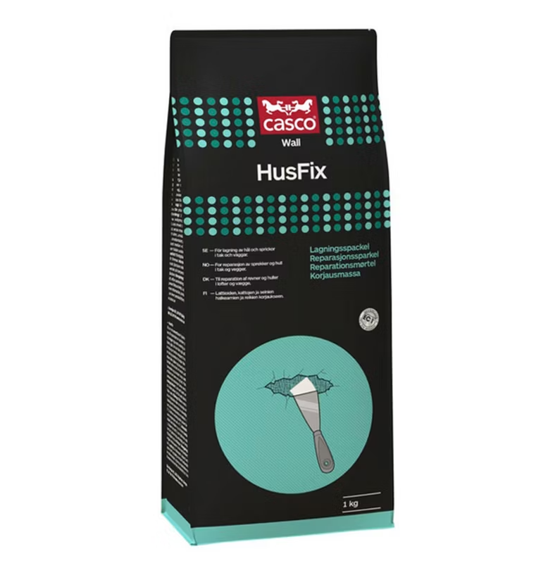 Svart-turkos Casco Wall HusFix-spackelpåse med röd logotyp och spackelspade vid hål