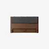 A wooden headboard with a rectangular shape, featuring a dark gray cushioned panel across the top and a simple, minimalist design. The wood has a smooth finish and warm brown tone.