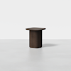 A modern, dark wooden side table with a rectangular top and a solid, rounded base, set against a plain white background.