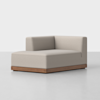 A modern, light gray upholstered corner sofa seat with a low, boxy design and a wooden base, set against a plain white background.