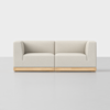 A modern, minimalist beige sofa with clean lines, featuring a light wooden base, set against a plain white background.