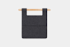 A dark gray felt organizer with two pockets, hanging from a light wooden rod against a plain white background.