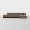 A modern, minimalist sectional sofa with three seats and a chaise lounge, upholstered in light brown fabric, set against a plain white background.