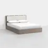 A modern bed with a light wood frame, a padded beige headboard divided into sections, and neatly arranged white bedding and pillows, set against a plain white background.