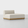 A modern, low-profile beige chaise lounge with a wooden base is set against a plain white background. The chaise has a single backrest on the left side and clean, minimalist lines.