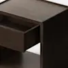 A dark wooden cabinet with short legs is shown against a plain white background. One drawer on the left side of the cabinet is pulled open, revealing an empty interior.
