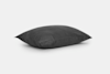 A rectangular, dark gray pillow with a smooth fabric cover is shown against a plain white background. The pillow appears soft and slightly fluffed, resting at a slight angle.