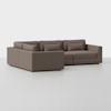 A modern brown sectional sofa with clean lines, low backrests, and matching cushions, placed on a plain white background.