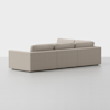 A modern beige sectional sofa with clean lines and three back cushions, viewed from the back on a light gray floor against a plain white background.