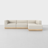 A modern, light beige L-shaped sectional sofa with clean lines and a wooden base, set against a plain white background on a smooth, light gray floor.