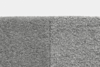 Close-up of a gray carpet with two different textures; the left side has a smoother, denser weave while the right side shows a more pronounced, looped texture. The image is taken from above against a white background.