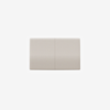 A beige rectangular light switch with a subtle textured surface and a vertical line dividing it into two equal sections, set against a plain white background.