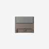 A modern wooden headboard with a gray cushioned panel attached near the top, set against a plain white background.