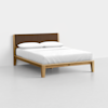A modern wooden bed frame with a brown upholstered headboard and white linens, including two pillows.