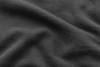 Close-up of soft, dark gray fabric with visible texture and gentle folds, creating smooth, wavy patterns across the surface.