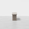 A wooden bench on a white floor.