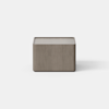 A modern, minimalist wooden nightstand with a single drawer partially open, placed on a light gray floor against a plain white background.