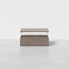 A rectangular wooden box with a light grey finish is shown with its lid hovering above, revealing an empty interior, against a plain white background.
